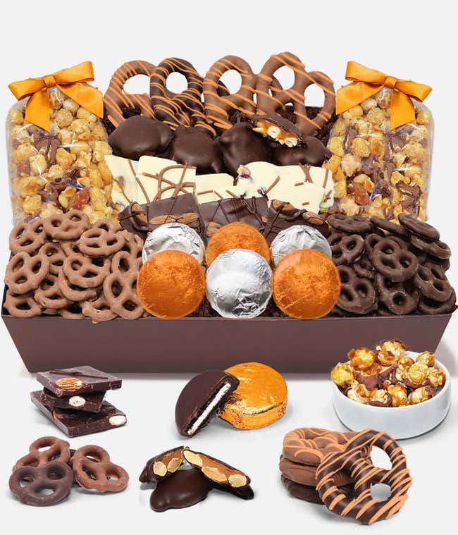 An indulgent assortment featuring 6 OREO&reg; cookies covered in Belgian milk chocolate, Belgian milk and dark chocolate covered mini pretzels, large pretzel twists, Belgian chocolate almond and pistachio bark, caramel popcorn, and caramel cashew clusters, in