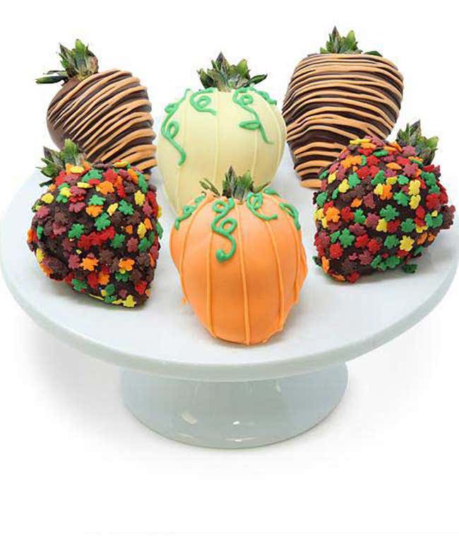 6 strawberries decorated for Fall and dipped in chocolate