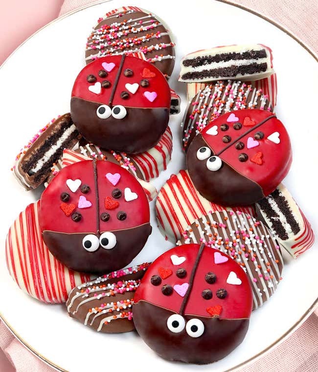 One dozen Oreos designed to look like ladybugs, or drizzled with pink and red chocolate.