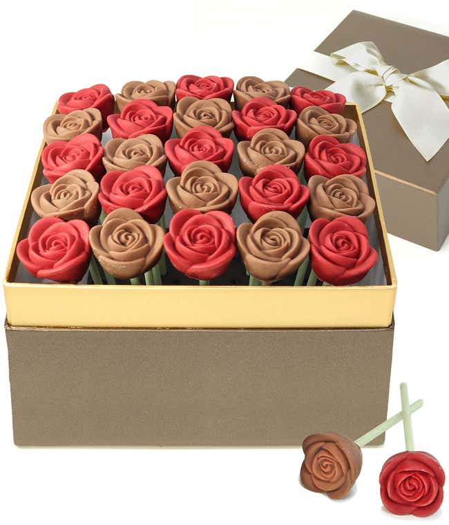 Valentine&rsquo;s Day chocolate rose gift box featuring red and milk chocolate rose-shaped candies arranged in a gold-trimmed box, with a ribboned gift lid and two chocolate rose pops displayed in front.