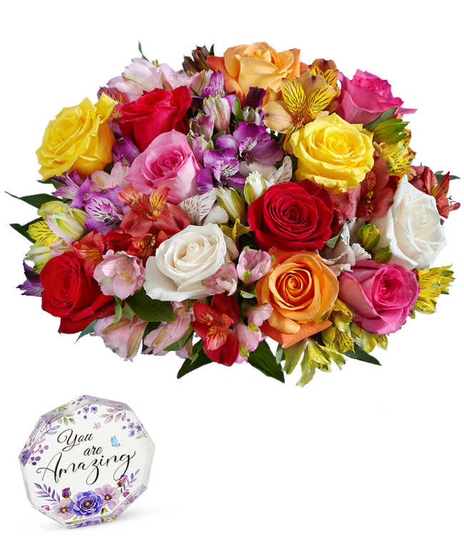 Partial image of A bouquet of 12 mixed roses and alstroemerias, with an optional vase. Next to a nonagon clear acrylic keepsake reading 'you're amazing' with purple flowers. without vase.