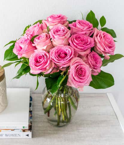 One Dozen Light Pink Long Stem Roses in a Clear Glass Vase