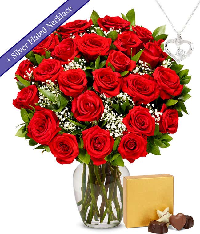 Two dozen red roses with a silver heart necklace on a chain and a small box of assorted chocolates