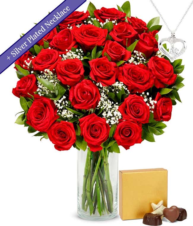 Two dozen red roses with a silver heart necklace on a chain and a small box of assorted chocolates