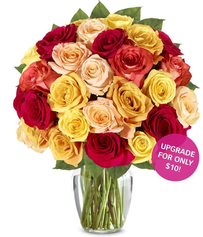 A stunning floral arrangement featuring orange roses, red roses, and yellow roses, optionally presented in a glass vase.