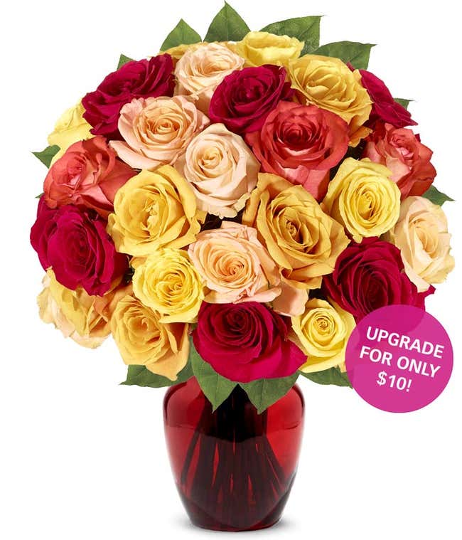 A stunning floral arrangement featuring orange roses, red roses, and yellow roses, optionally presented in a glass vase.