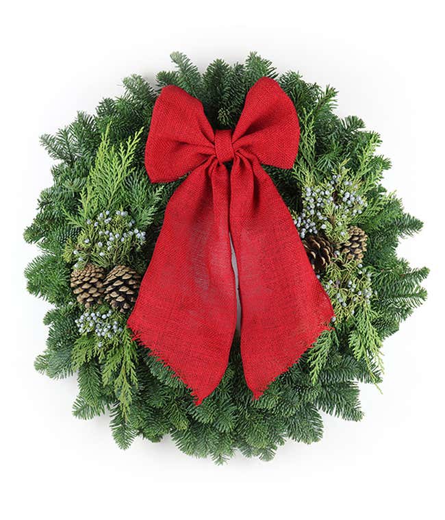Large green wreath accented with pinecones and a big red bow
