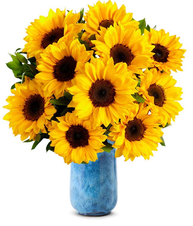 Bouquet of vibrant sunflowers arranged in a clear glass vase.