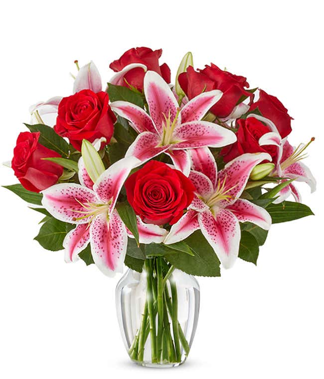 Red roses arranged with pink stargazer lilies