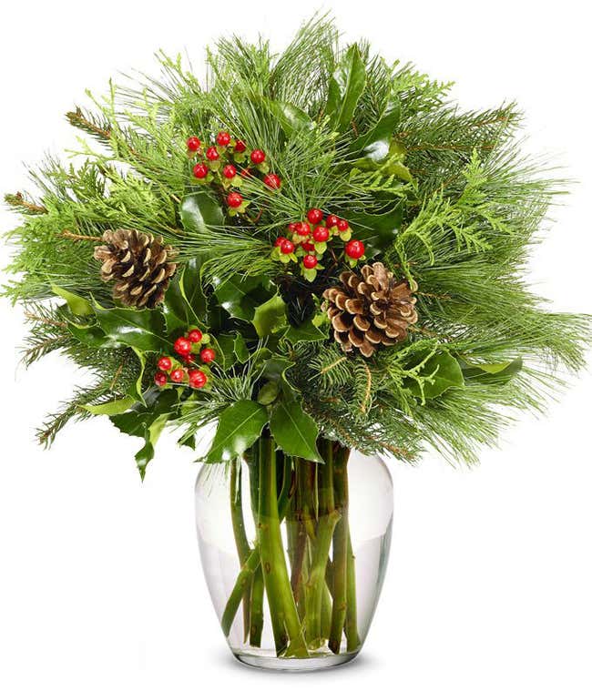 Seasonal greens complemented by decorative pine cones and vibrant red hypericum berries, perfect for a festive holiday arrangement.