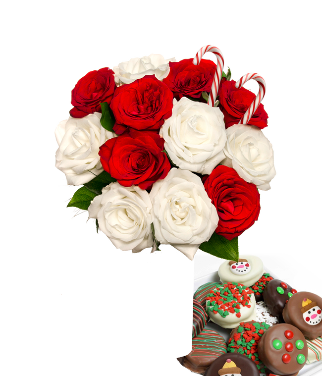 Partial image of 6 red and 6 whtie roses and 2 candy canes popping out of a glass vase with some leaves showing. Next to it is a plate of chocolate cookies with red/green sprinkles, candy, and snowmen. without vase.