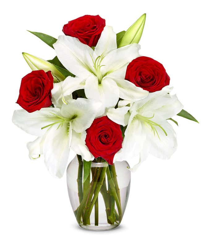 White Asiatic Lilies arranged with red roses