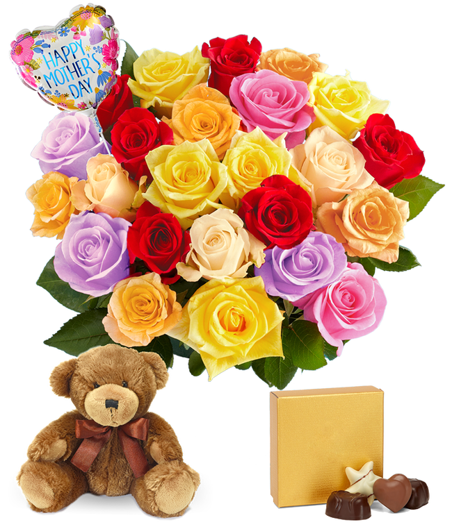 Partial image of Two Dozen Rainbow Roses in a clear glass vase with a teddy bear, box of chocolates, and heart shaped mylar balloon without vase.