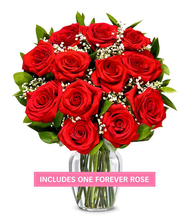 One Dozen Red Roses in a clear glass vase