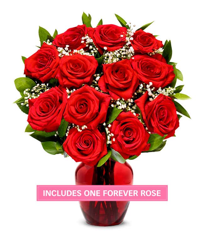 One Dozen Red Roses in a clear glass vase