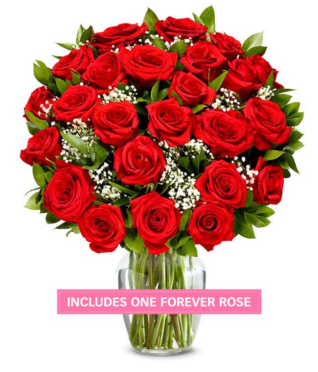 Two dozen red roses in a clear glass vase