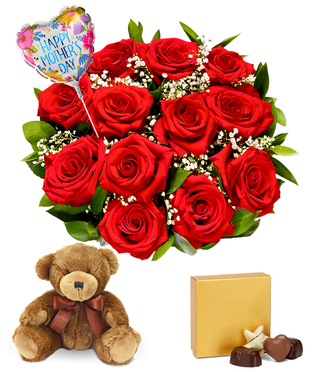 Partial image of dozen red roses with greenery and baby's breath in a clear glass vase. Sat next to it is a brown teddy bear and a brown &amp; gold square box of chocolates. And a pink and red heart shaped balloon reading happy mother's day without vase.