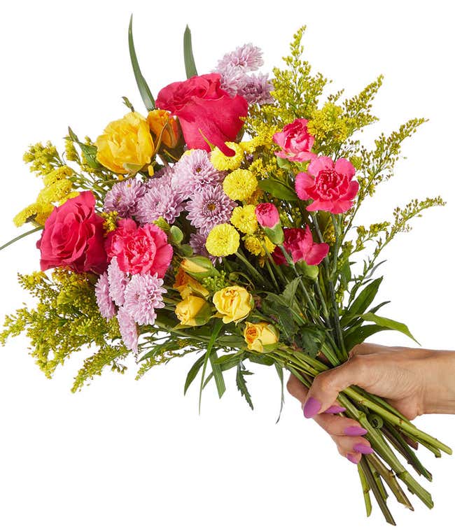 A cheerful bouquet of yellow spray roses and peach roses, lavender daisies, yellow daisies, and greenery arranged as a bouquet.