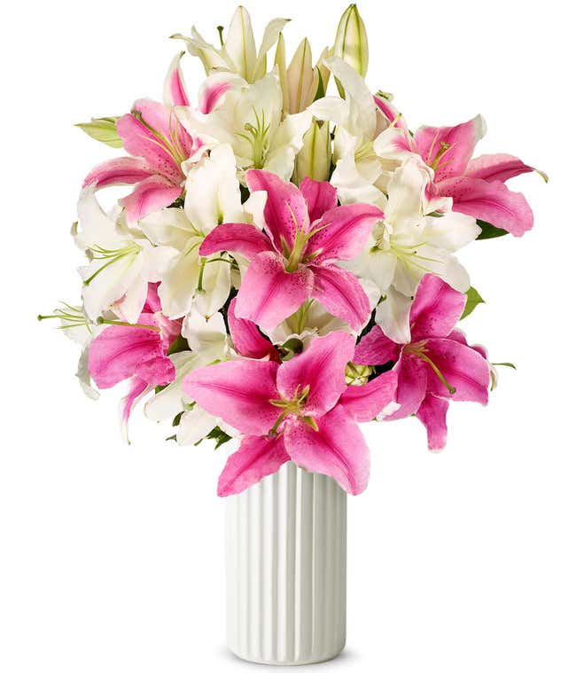A bouquet featuring pink lilies and white lilies, with an optional glass vase.