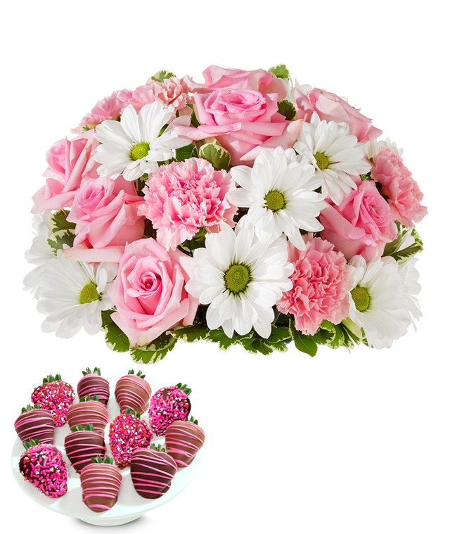 Partial image of Deluxe bouquet of pink roses, pink carnations, and white daisy poms in a clear glass vase, paired with chocolate-covered strawberries decorated with pink drizzle and pink sprinkles. without vase.