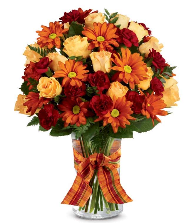Fall flowers delivered in a glass vase, beautiful Thanksgiving flower arrangement.