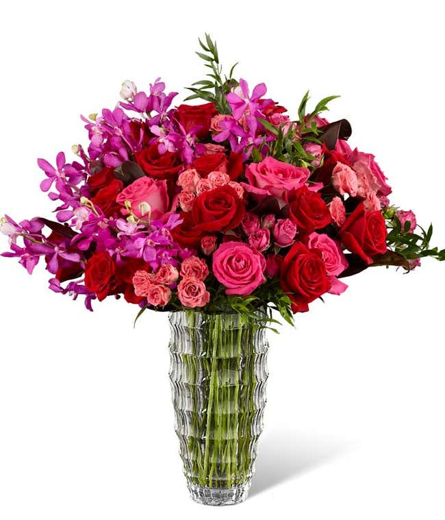 hot pink flowers arranged with red roses