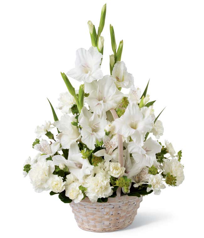 While gladiolus, alstroemeria, and carnations, with fresh greens arranged into a white floor basket