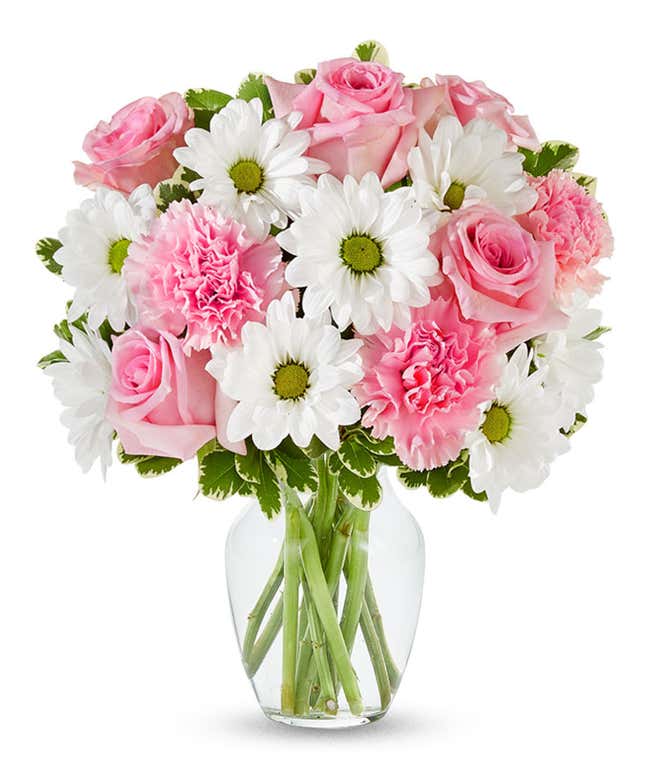 Pink roses, pink carnations and white daisies in a pink vase