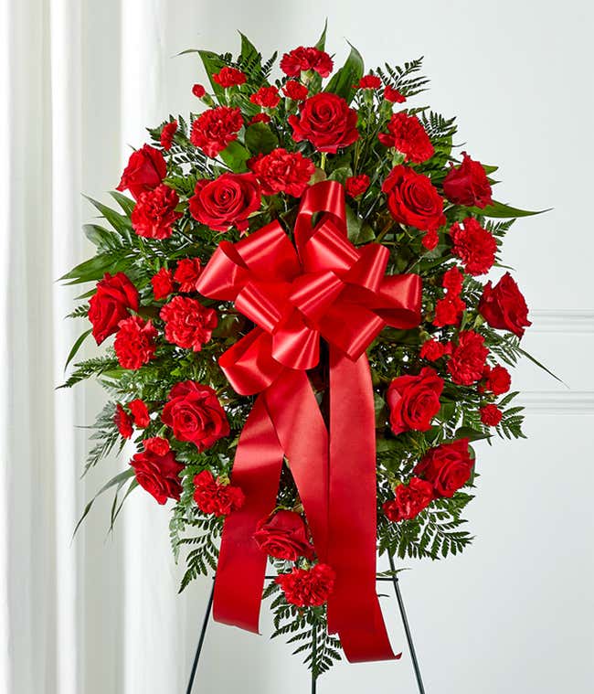 Sympathy standing spray with red flowers