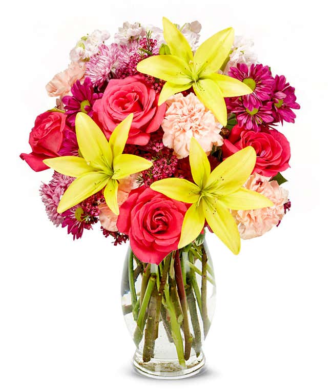 Yellow lilies, pink roses, pink daisies all in a vase
