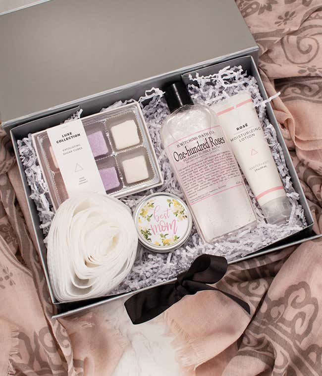 Mother's Day spa gift box with rose-themed bath products, including exfoliating sugar cubes, bubble bath, rose lotion, a 