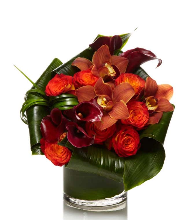 cymbidium orchids arranged with Burgundy calla lilies