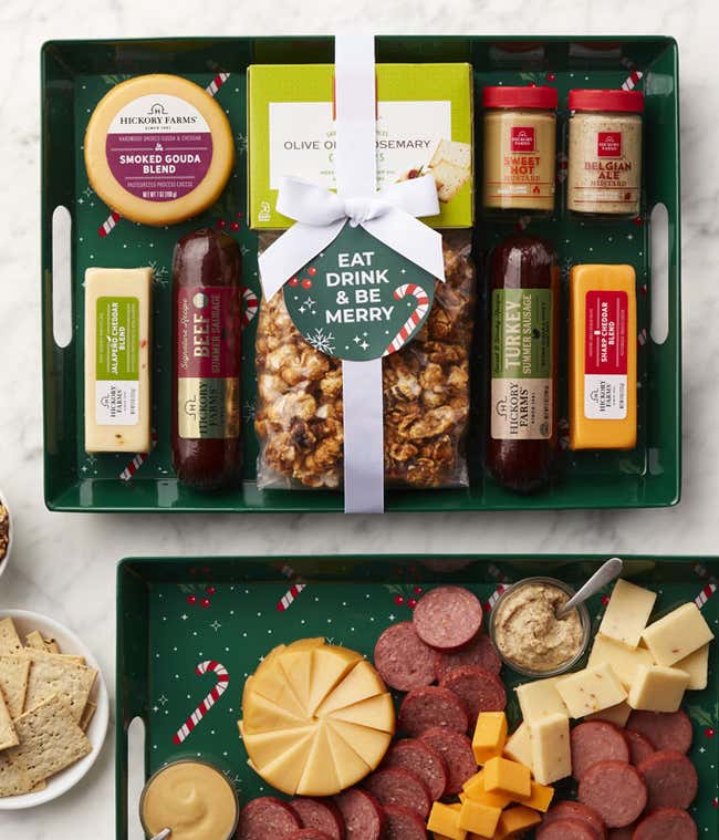 Holiday gift set with a green tray with smoked gouda blend, two summer sausages, golden toasted crackers, Belgian ale mustard, sweet hot mustard, caramel popcorn, and a tag that says Eat, Drink &amp; Be Merry