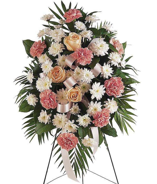 Pastel roses and carnation funeral flower stand