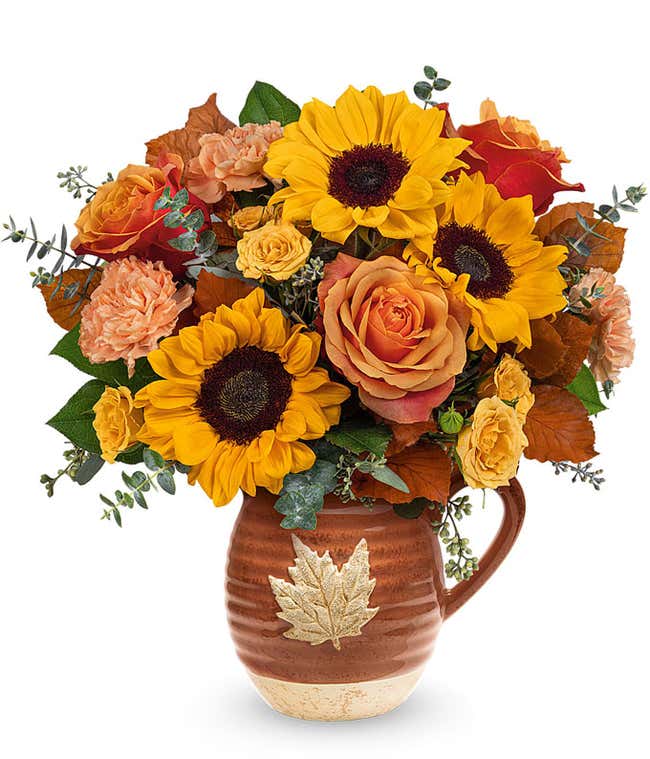 Orange and yellow roses, peach carnations, yellow sunflowers, brown copper beech, seeded &amp; spiral eucalyptus, 