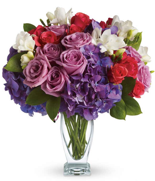 Purple roses with purple hydrangea in a vase