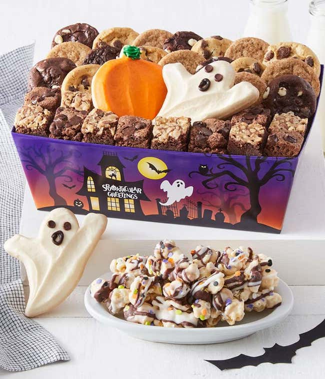 Bite sized cookies, brownie bites, ghost and pumpkin themed cookie cut outs, and popcorn all individually wrapped inside a haunted mansion themed gift box.