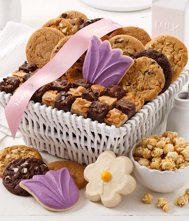 A beautifully arranged Mother's Day gift basket filled with an indulgent assortment of treats, including cookies, brownie bites, frosted cookies, and toffee nut popcorn. Perfect for celebrating Mom's special day!