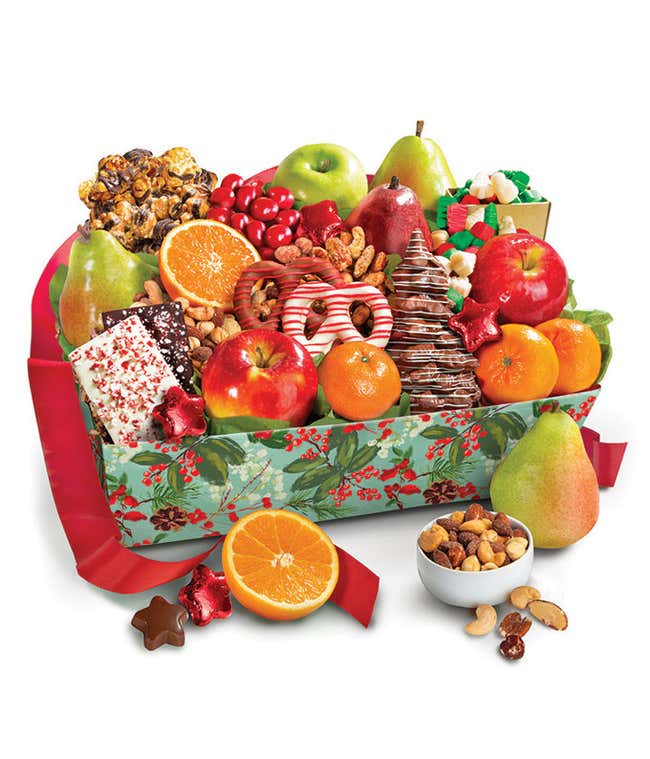 Festive holiday gift basket filled with assorted fruits, including apples, pears, and oranges. The basket also contains chocolate-covered pretzels, peppermint bark, caramel popcorn, mixed nuts, and holiday-themed candies, decorated with a red ribbon.