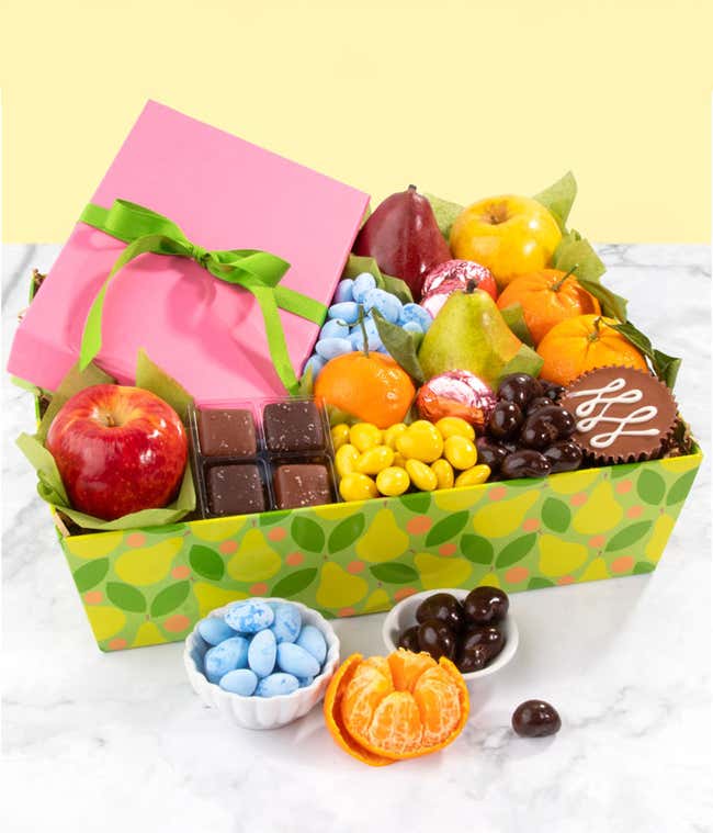 milk chocolate covered sandwich cookies, milk chocolate peanut butter cup, chocolate sea salt caramels, green and red D'Anjou pears, red apple, mandarins, chocolate cashews, lemon drops, and blue robin's eggs. 