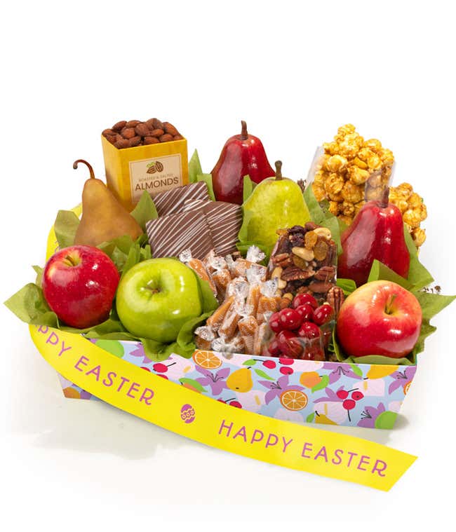 Easter gift basket with fresh pears and apples, chocolate covered grahams, caramel popcorn, vanilla caramels, roasted almonds, trail mix, and chocolate cherries in a festive tray with Happy Easter ribbon.
