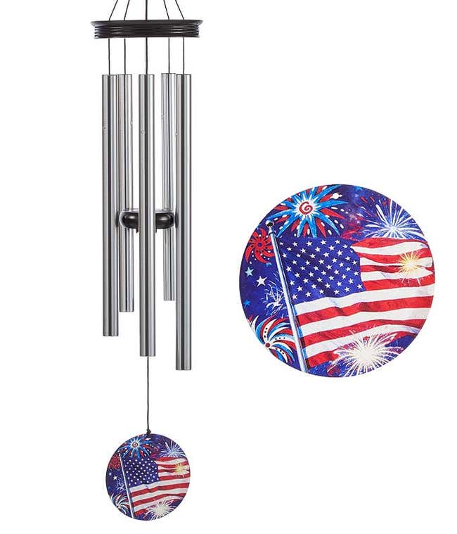 A windchime with metal rods and a wooden accents and sail. Blue sail is decorated with American flag and fireworks.
