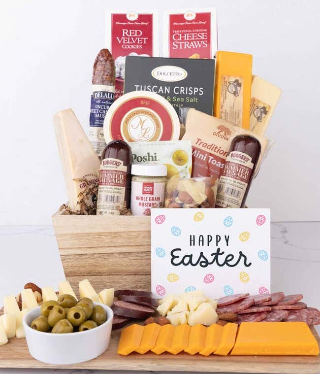 A wooden gift basket filled with summer sausages, 3 cheeses, Tuscan crisps, mini toasts, red velvet cookies, cheese straws, nuts, whole grain mustard, and brie with an Easter card.