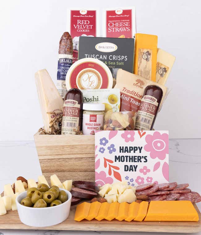 Wooden charcuterie gift crate filled with artisan summer sausage, cheeses, brie, Tuscan crisps, olives, mustard, and savory snacks, displayed with a Happy Mother&rsquo;s Day card and arranged with sliced meats and cheeses.