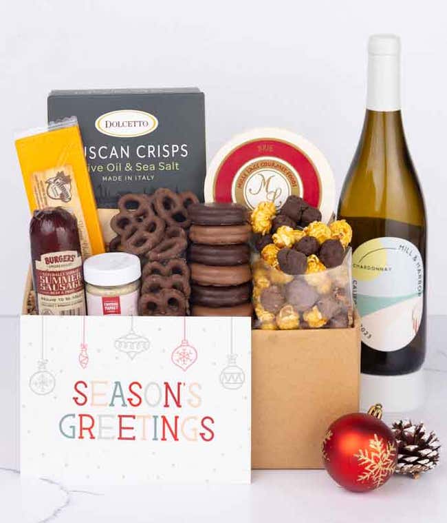 A gift set with a bottle of California Chardonnay, focaccia crisps, two cheeses, mustard, summer sausage, caramel popcorn, chocolate pretzels, six chocolate-covered Oreos and a Season's Greetings card to complete the gourmet experience.