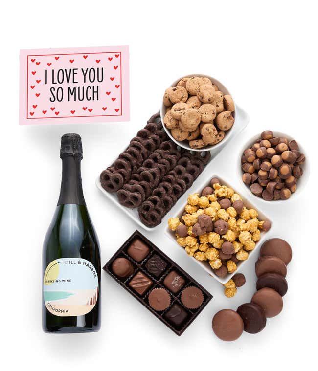 A gift set featuring a bottle of California Sparkling Wine paired with chocolate-covered pretzels, mini cookies, caramel popcorn, chocolate peanut butter buckeyes, 6 chocolate-covered Oreos, a box of assorted chocolates, and Birthday card.