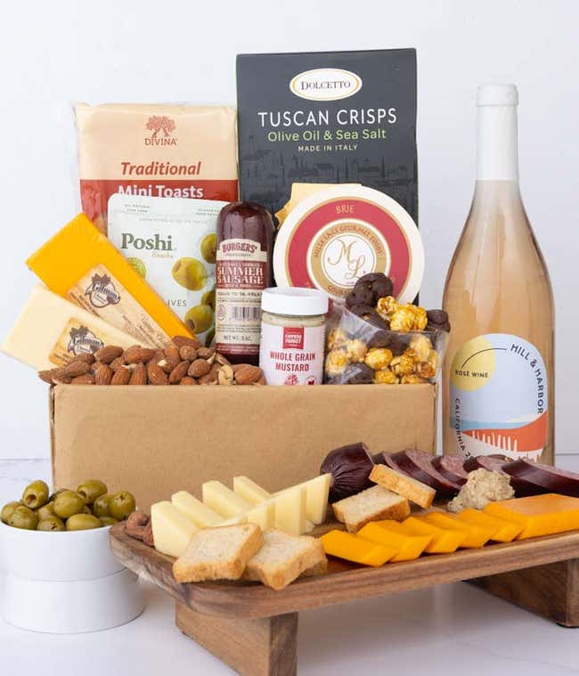 An abundant gift box filled with California Ros&eacute; Wine, assorted crackers, three cheeses, summer sausage, and snacks to make an amazing charcuterie spread. 