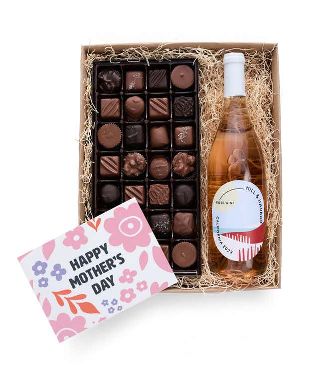 A gift box with Hill &amp; Harbor Ros&eacute; wine and a 1 lb. box of assorted artisan chocolates with a 'Happy Mother's Day' card placed on top.