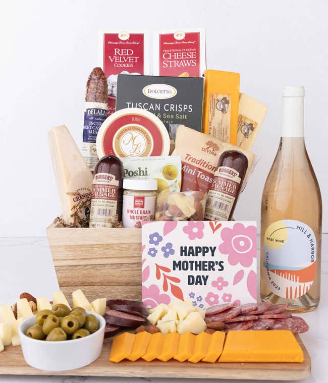 Mother&rsquo;s Day charcuterie crate featuring Hill &amp; Harbor Ros&eacute; with artisan sausage, cheeses, olives, Tuscan crisps, mustard, cookies, and savory snacks, styled with sliced meats, cheeses, and a floral card.