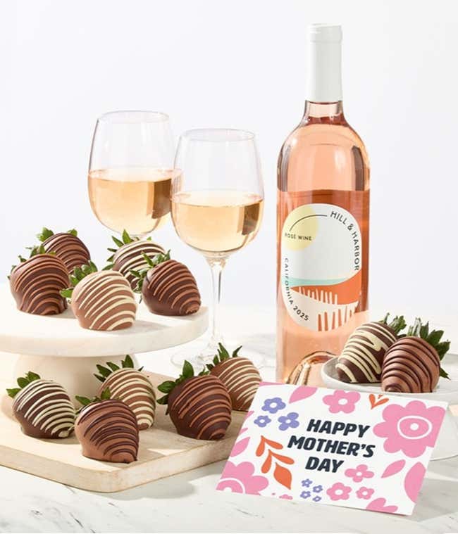 Hill &amp; Harbor ros&eacute; wine bottle displayed with two glasses and assorted chocolate-covered strawberries on trays, styled with a floral Happy Mother&rsquo;s Day card for a fresh wine and dessert gift.